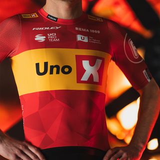 Uno-X's new kit, a largely red jersey with a yellow band across the chest