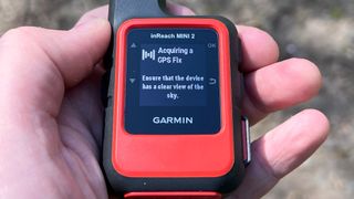 Garmin inReach Mini 2 hiking GPS in someone's hand