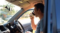 Man having his morning coffee on the move after waking up at 5am