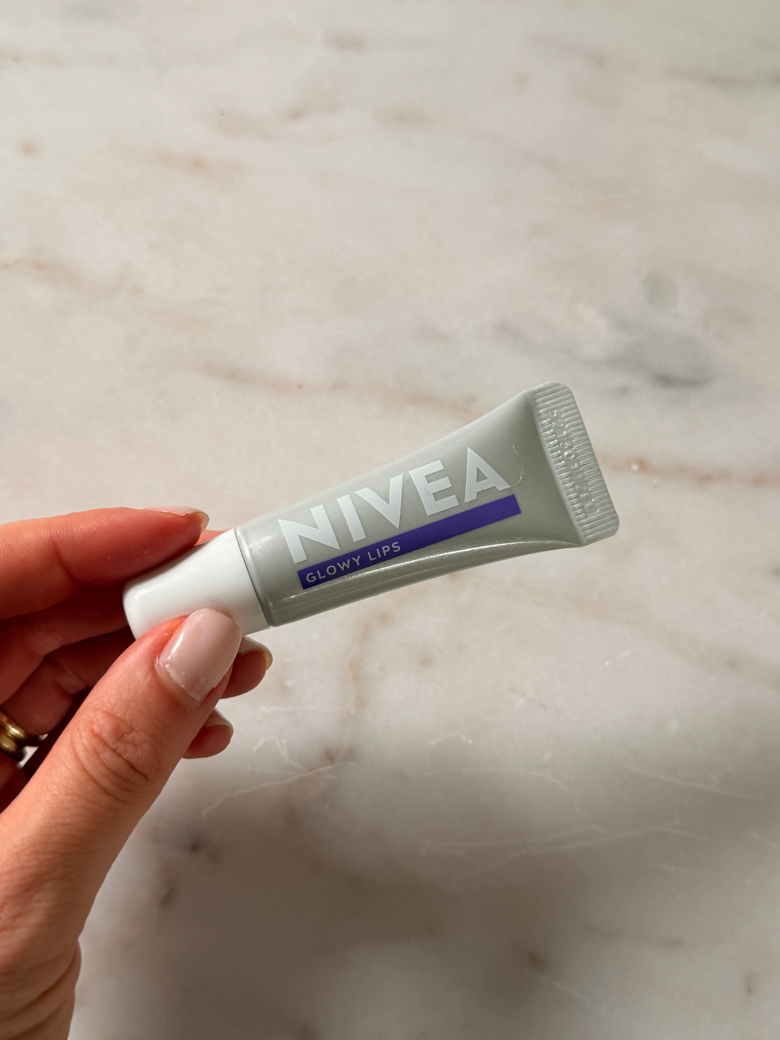 Grace holding the Nivea Hyaluron Lip Balm