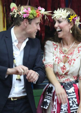 Prince William and Kate Middleton dancing wearing flower crowns