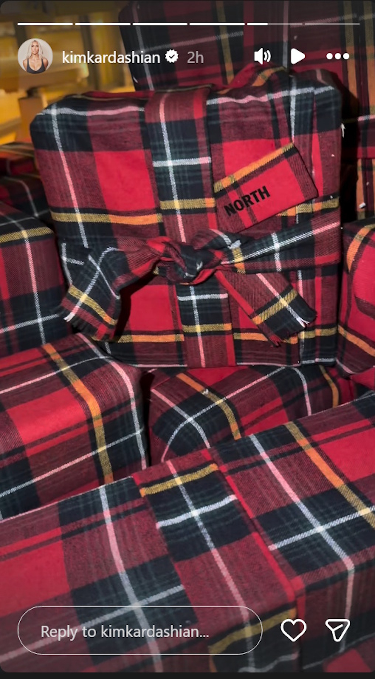 Kim Kardashian shows the SKIMS flannel pajama wrapping that North West chose for Christmas 2025.