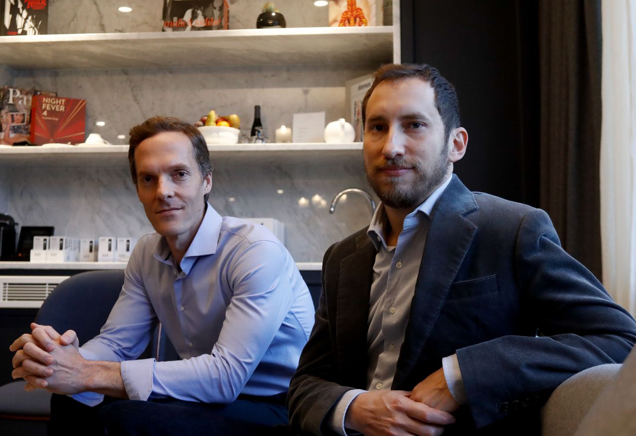 Co-founders of US start-up company Juul, Adam Bowen (L) and James Monsees pose in Paris on December 5, 2018