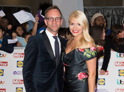 Holly Willoughby and Dan Baldwin pose on the red carpet