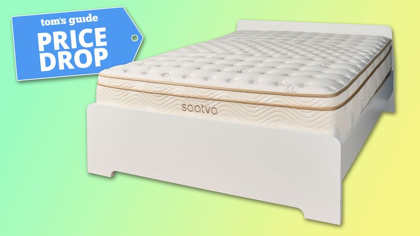 The Saatva Classic mattress on a white bedframe against a green and yellow background, a Tom's Guide Price Drop deals badge in the top left corner