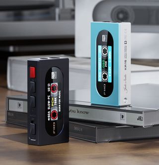 Black and blue Fiio KA15s on top of CD cases