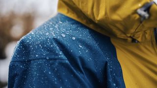 Rain beading on shoulder of waterproof jacket