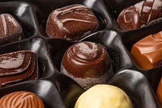 These old praline chocolates are blooming with white marks.