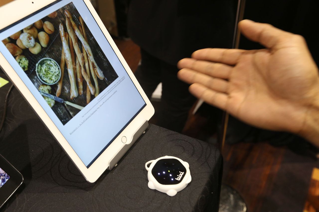 A page on a device is turned with the wave of a hand over the bixi gesture-controlled contactless motion sensing device at The CES Unveiled press event, January 4, 2016 in Las Vegas, Nevada a