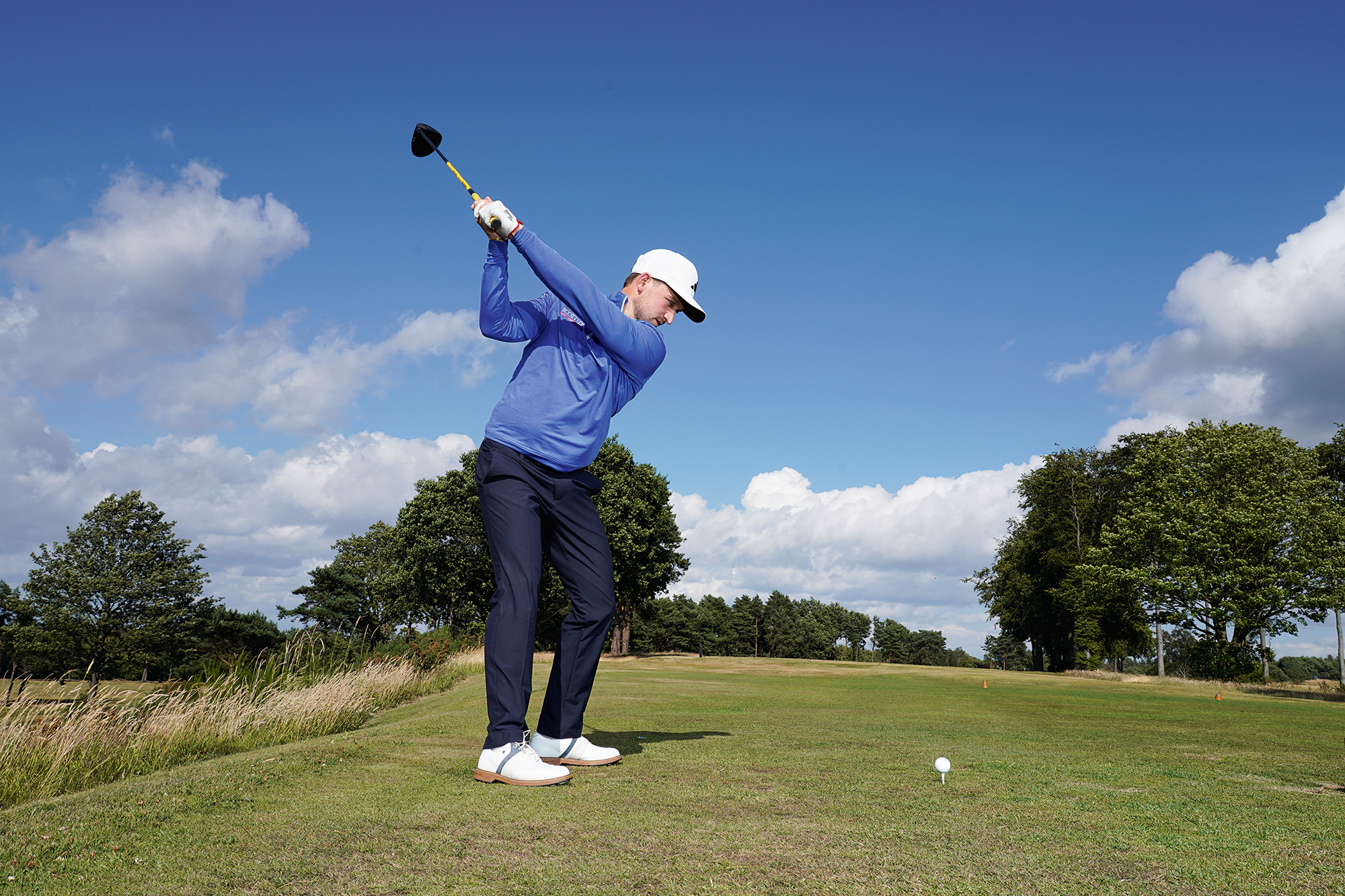 Alex Elliott at the top of his backswing, demonstrating a key position for improving driver distance