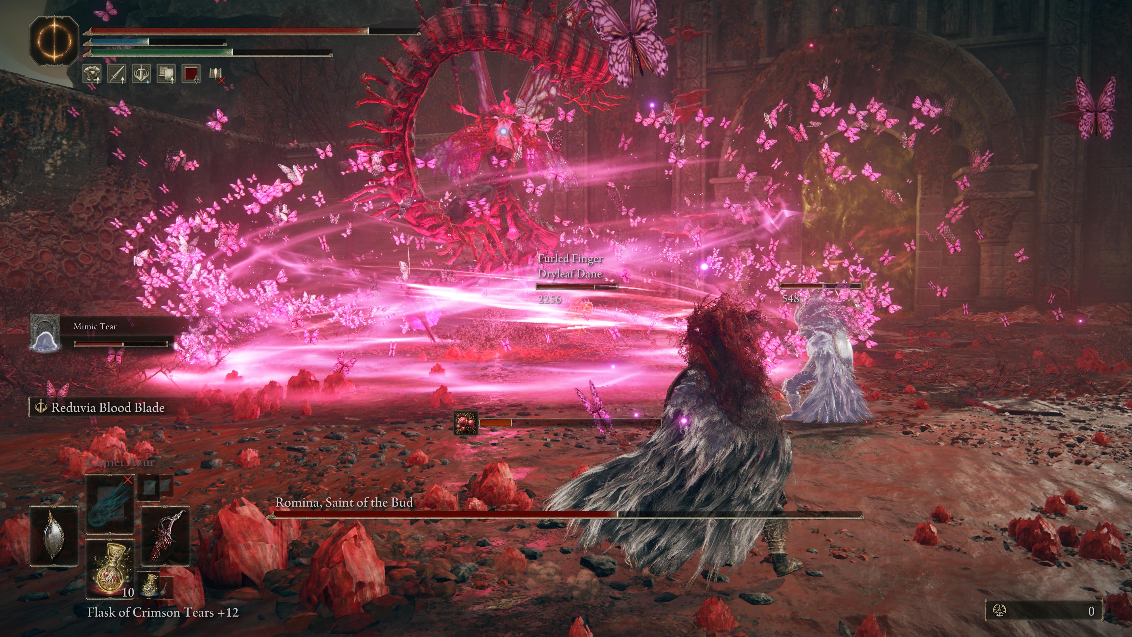 Romina, Saint of the Bud attacks the player who has a Mimic Tear and Drylead Dane at their side in Elden Ring: Shadow of the Erdtree - the strange scorpion-tailed creature spinning to summon deadly purple butterflies