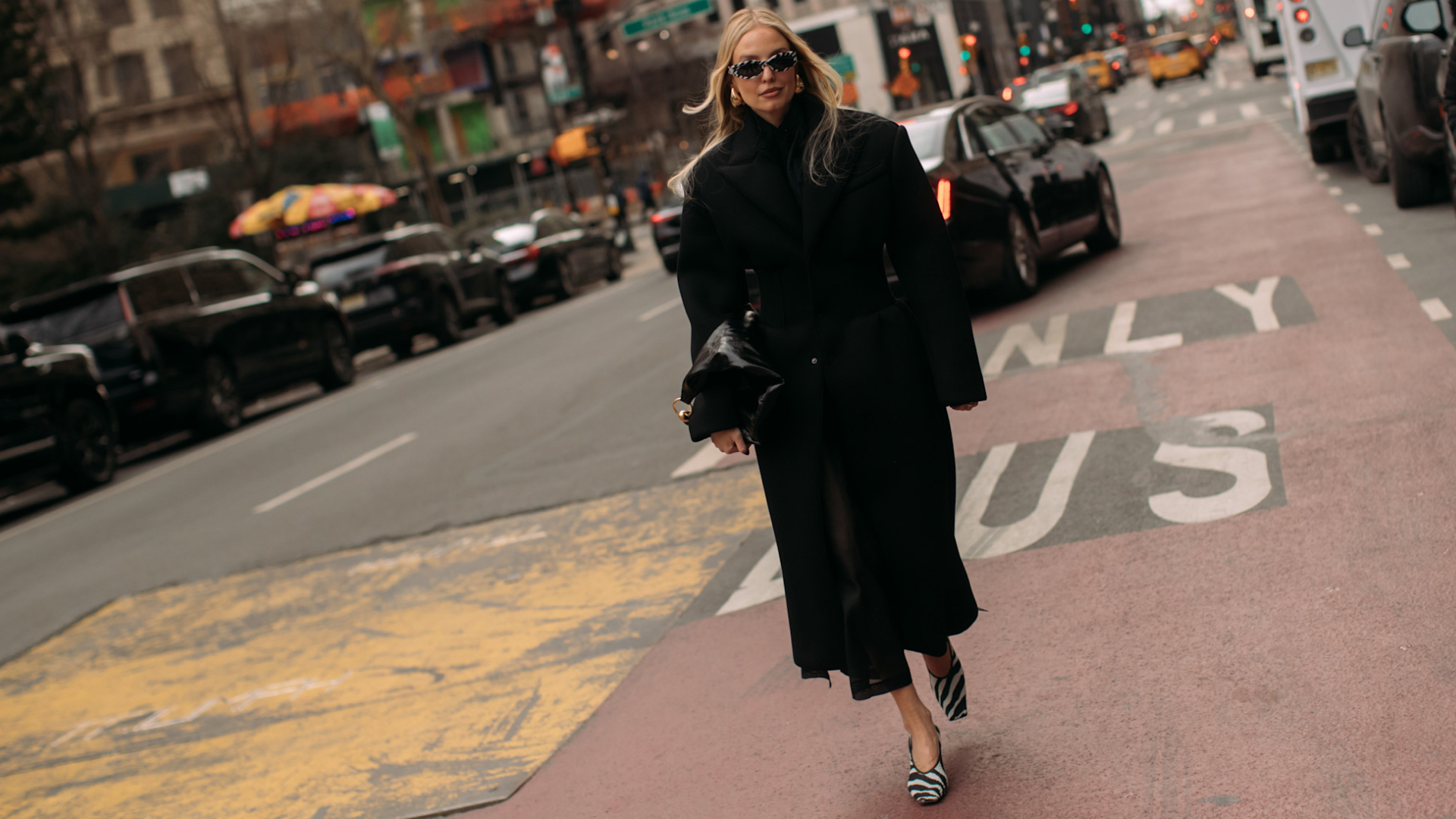 woman walking down street wearing zebra print shoes