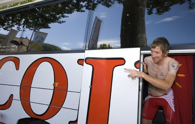 Bradley Wiggins, then at Cofidis, jumps out from the team bus at the Tour de France