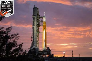 giant space launch system rocket on launch pad at sunset
