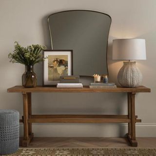 A wall mirror above a console table