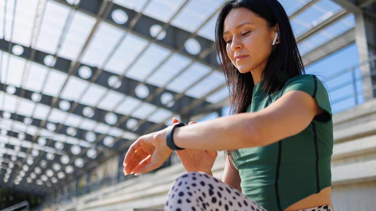 Woman checking sports watch during workout