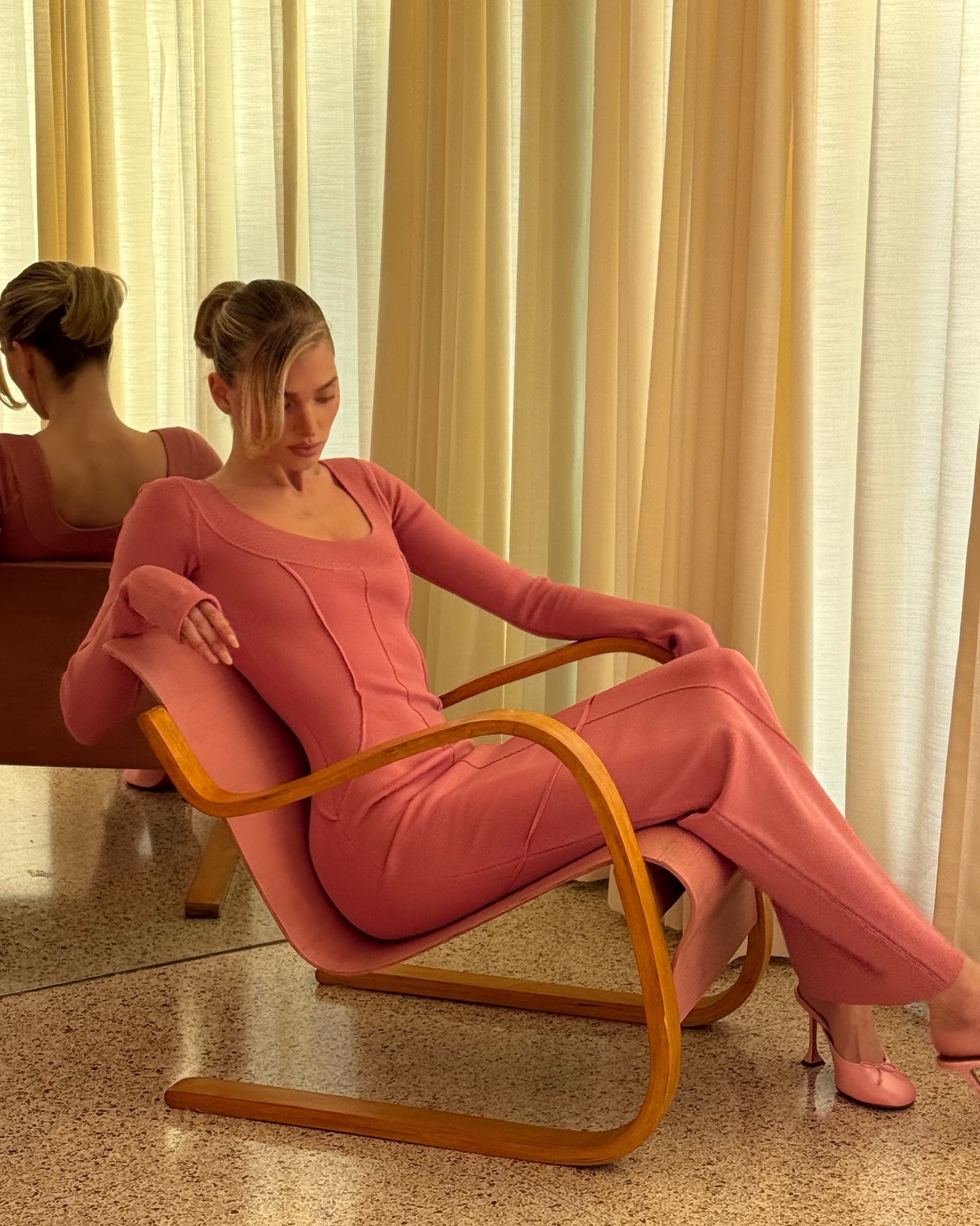 Elsa Hosk wearing a pink dress with her bob hairstyle styled into a ponytail