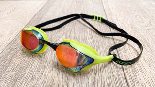 Zone3 Volare Streamline Racing Goggles on a wooden floor