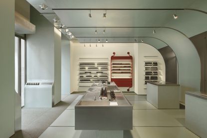 aesop milan store interior showing minimalist table with product