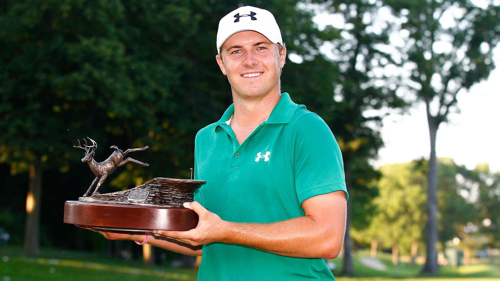 Jordan Spieth holds the John Deere Classic trophy