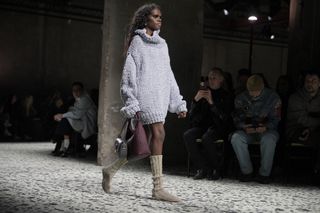 A model walks the runway at Bottega Veneta in sock boots