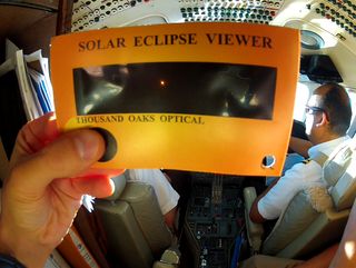 Partially-Eclipse Sun Seen Out of Cockpit Windows