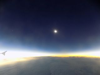The total solar eclipse of March 20, 2015 reaches its maximum phase, or totality, as seen from an eclipse-chasing jet over the North Atlantic Ocean.
