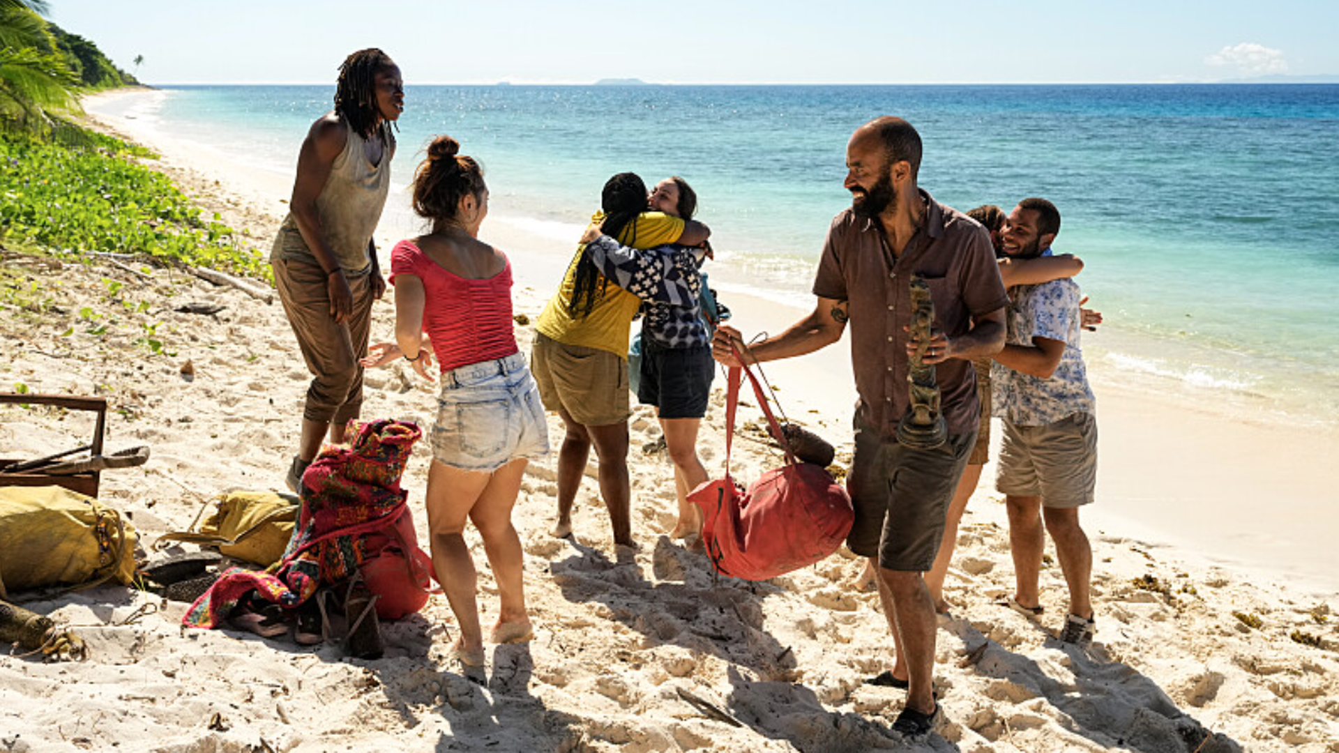 MC, Savannah and Nate watch on as Kristina and Sophi, and Sophie and Alex hug each other on Survivor 49