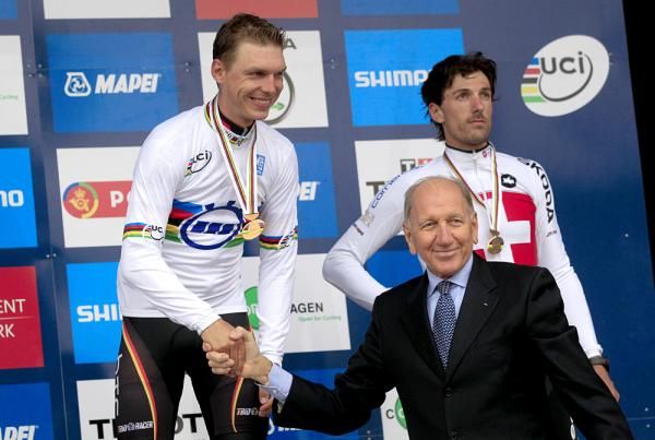 Tony Martin (Germany) on the top step of the podium is congratulated by Vittorio Adorni.
