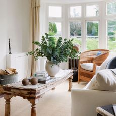country-style living room with rattan armchair and white sofa
