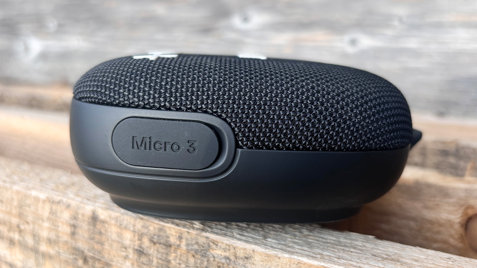 Tribit Stormbox Micro 3 Bluetooth speaker on wooden bench showing Micro 3 logo