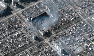 Maxar Technologies' WorldView-3 satellite captured this image of burning apartment buildings in the Ukrainian city of Mariupol on March 22, 2022.