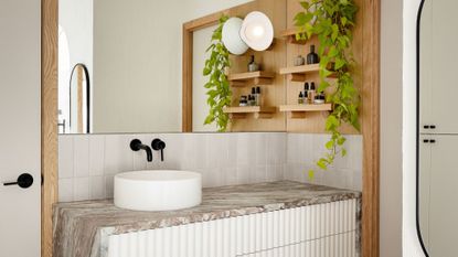 bathroom vanity in marble with fluted cabinet doors, long mirror and plant