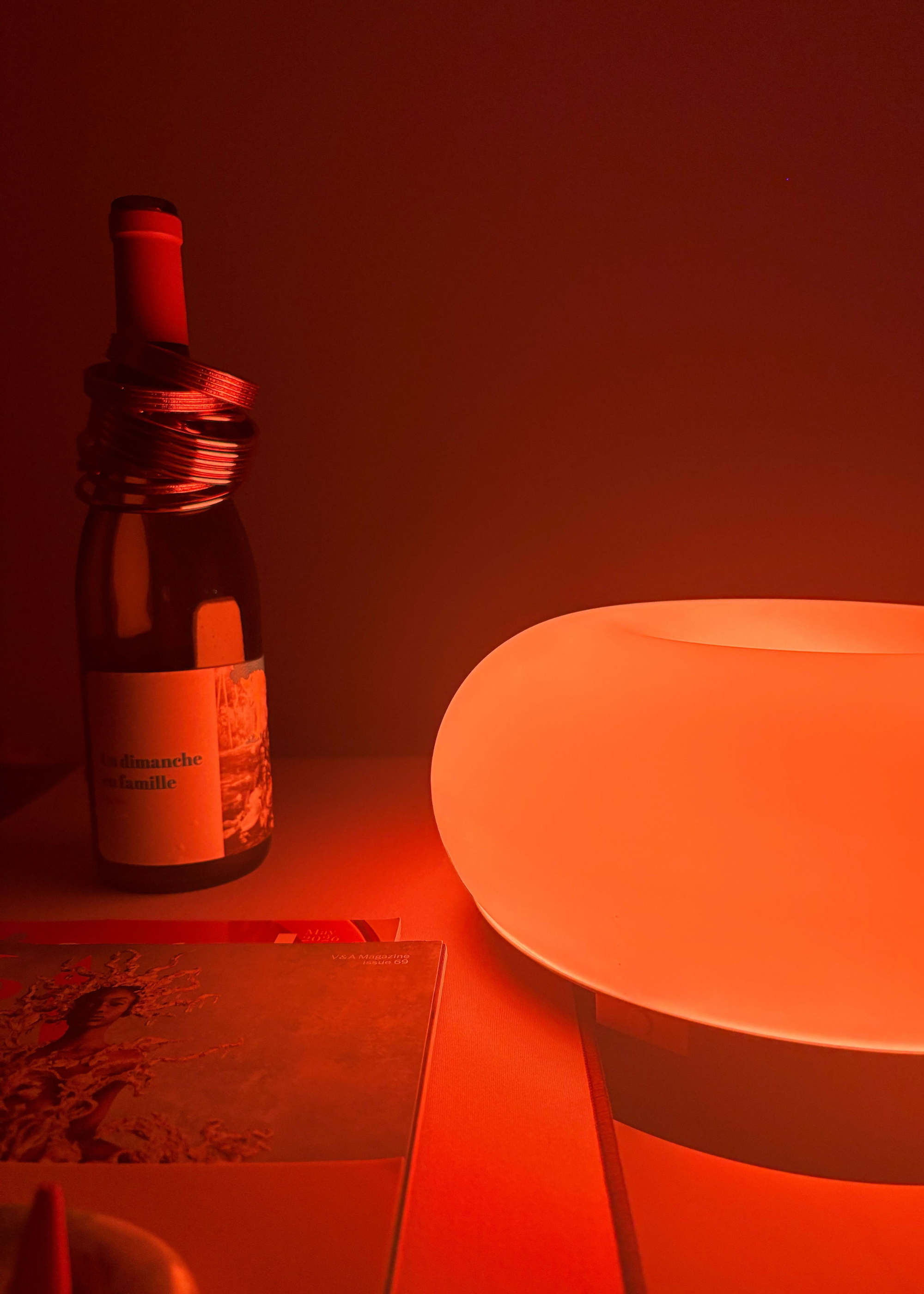 The IKEA VARMBLIXT donut lamp reflecting amber light
