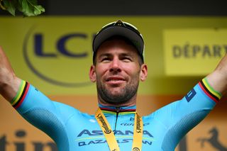 Mark Cavendish on the Tour de France podium in Saint-Vulbas after winning his record-breaking 35th stage this summer