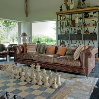 living room with chess set and sofa