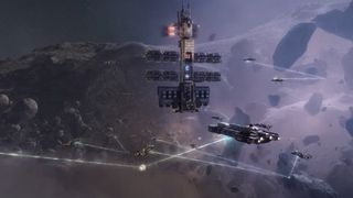 A mining fleet fires lasers at an asteroid belt