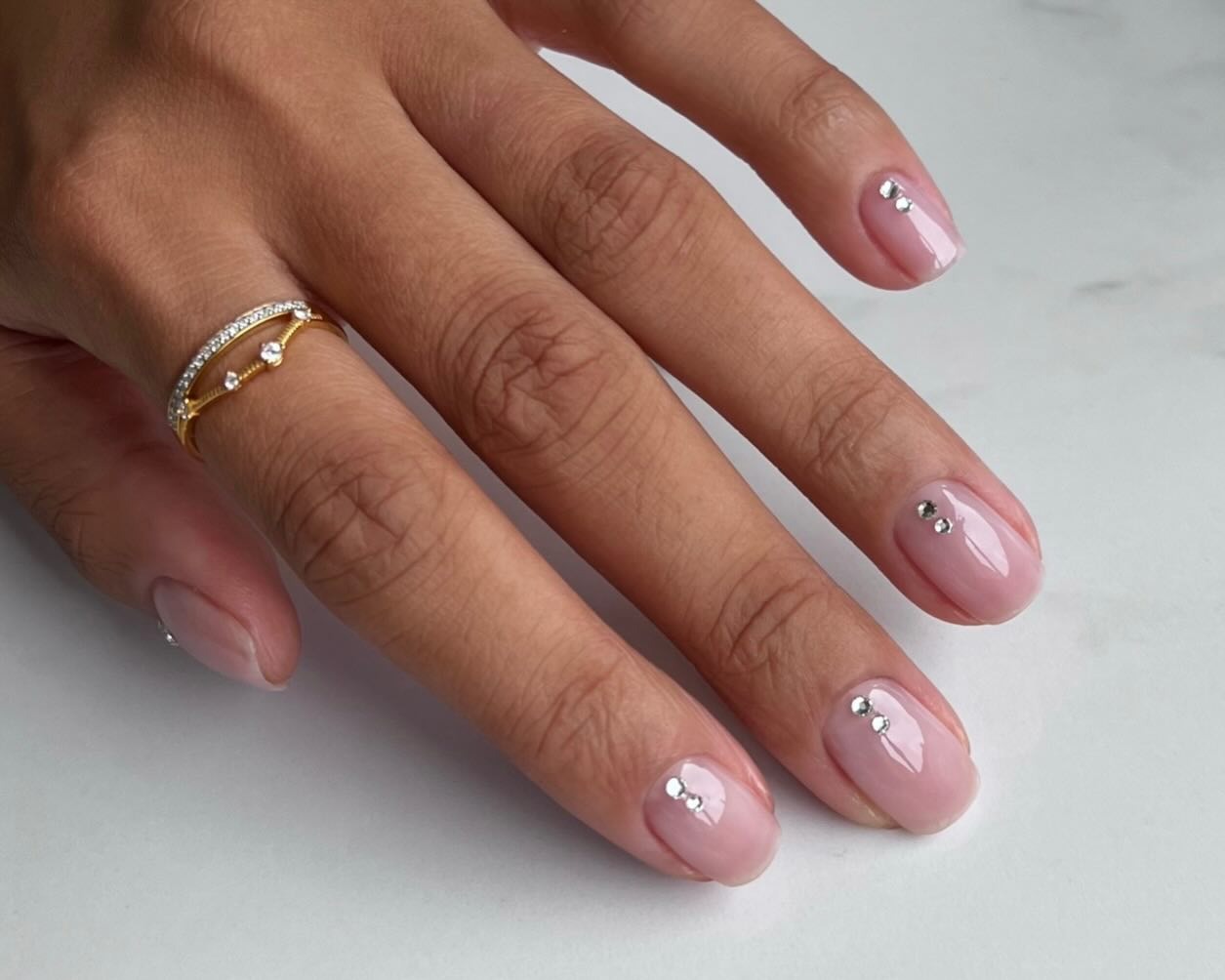A clear manicure with simple silver embellishments