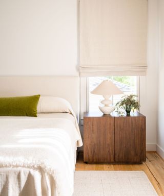 White bedding, wooden bedside table