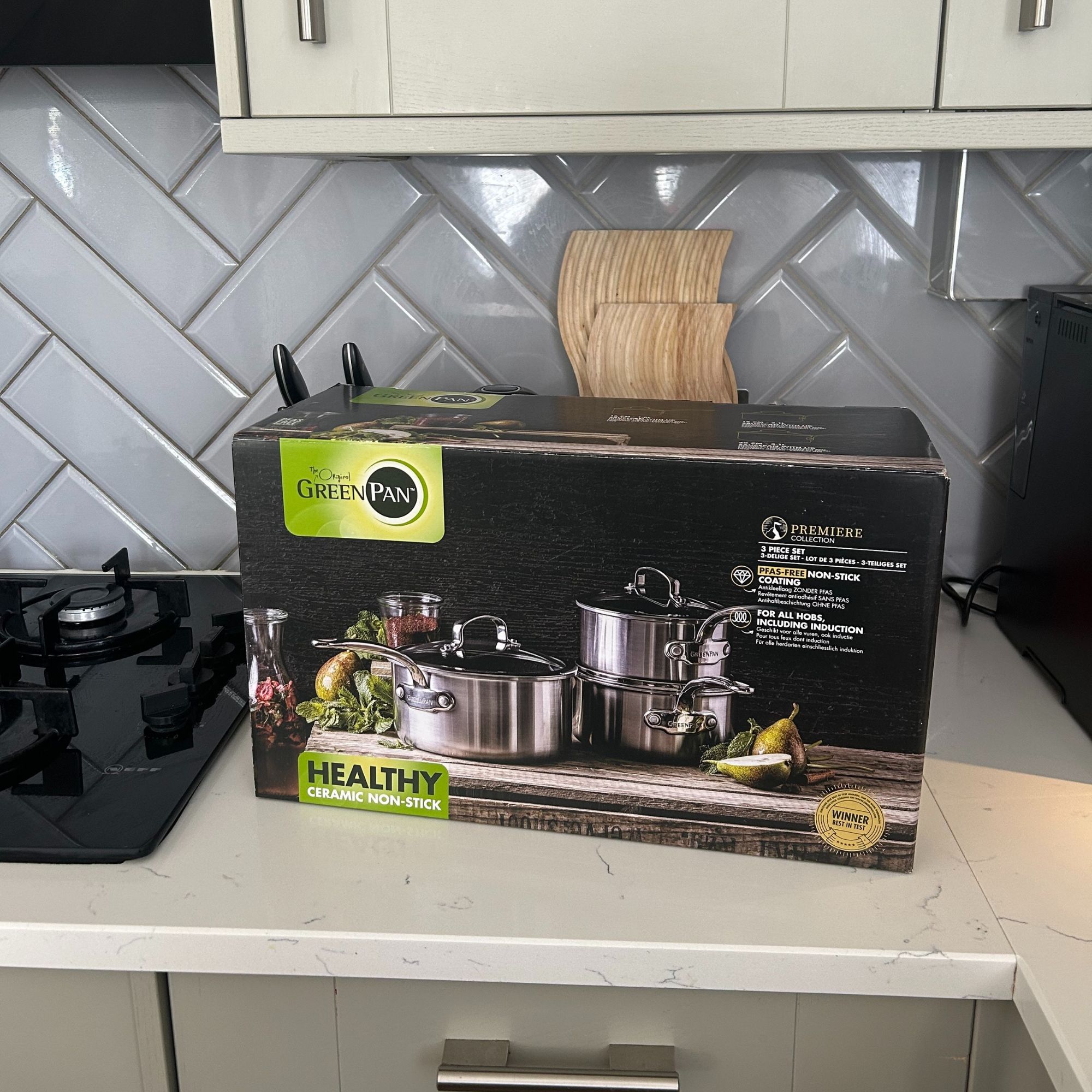 GreenPan Premiere Stainless Steel Ceramic Non-Stick Saucepan & Lid Set - in box on kitchen worktop