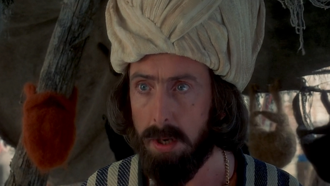 A close up of Eric Idle in Monty Python's Life of Brian.