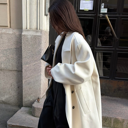 Woman wearing white coat.