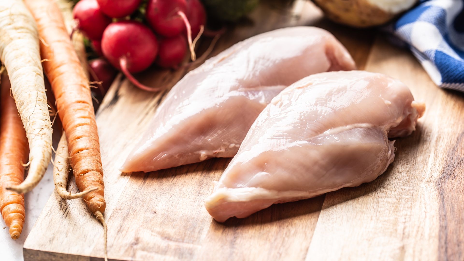 picture of raw chicken on wooden chopping board