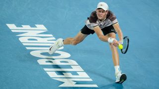 Jannik Sinner stretches for a return at the Australian Open 2024