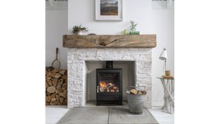 log burning stove in white brick wall