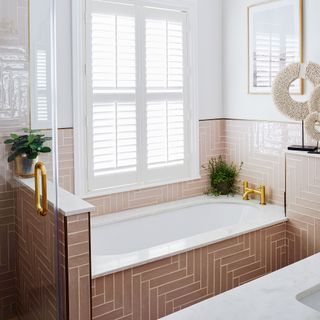 pink bathroom with pink subway tiles and tub