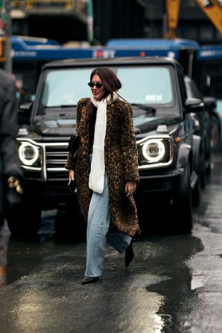 woman wearing animal print coat, jeans, scarf, and heels