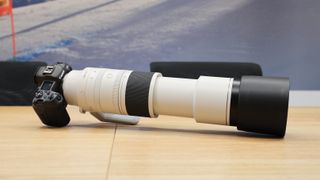 Canon RF 200-800mm f/6.3-9 IS USM lens on a Canon EOS R5 camera on a wooden table