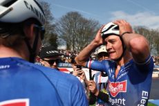 Mathieu van der Poel with his head in his hands at Paris-Roubaix