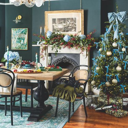 Dining room covered in christmas decorations, including a christmas tablescape and a christmas tree in the corner